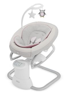 a baby's high chair with the seat up and stars hanging from the ceiling