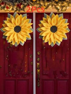 two sunflowers are on the front door of a red building with christmas decorations