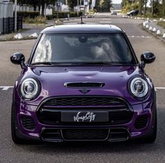 the front end of a purple mini cooper