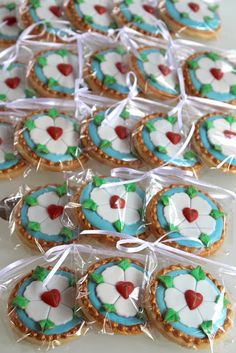 some cookies are wrapped in plastic and sitting on a table with ribbon around the edges