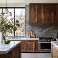 a kitchen with marble counter tops and wooden cabinets, along with an island in the middle