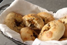 bread rolls with poppy seeds and seasoning in a basket