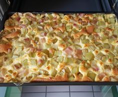 a casserole dish with ham, cheese and onions on it in an oven