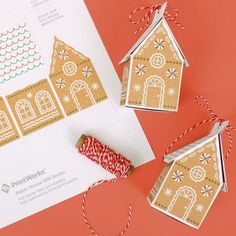 three gingerbread houses are on top of a piece of paper