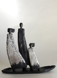 two black and white figurines are standing on a skateboard with their arms around each other