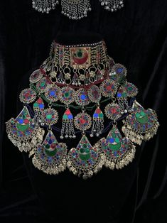 Exquisite Afghan Jewelry Set - Perfect for Special Occasions🇦🇫 Add a touch of exotic elegance to your look with our stunning Afghan jewelry set. Handcrafted by skilled artisans, each piece is a unique work of art that captures the rich cultural heritage of Afghanistan. This set includes a dazzling necklace, matching earrings, and a Tikka headpiece, all intricately designed with traditional Afghan motifs and embellished with vibrant Multicoloured gemstones. Balochi Doch Jewelry, Traditional Beaded Festival Jewelry, Ceremonial Multicolor Necklace With Intricate Design, Multicolor Necklace With Intricate Design For Ceremonial Occasions, Traditional Adjustable Jewelry For Festive Occasions, Red Motifs Jewelry For Rituals, Red Motif Jewelry For Rituals, Multicolor Ceremonial Necklaces For Festivals, Traditional Beaded Jewelry For Festival