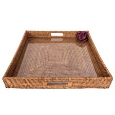 an empty wicker tray with a flower on it and a purple rose in the center