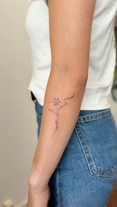 a woman with a small tattoo on her arm