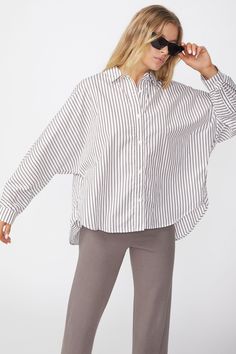 Style Information:Striped button front shirt with dolman sleeves. A great classic shirt that's easy to style at the office or out and about. The vertical stripes slim down the body and fits relaxed. Dolman Shirt, Linen Shop, Jacket Brands, Out And About, Button Front Shirt, Romper With Skirt, How To Slim Down, Vertical Stripes, Dress Romper