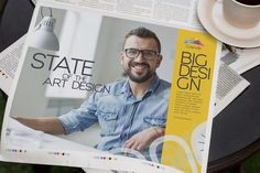 a man with glasses on top of a magazine