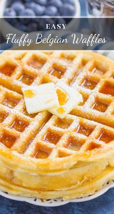 a waffle with butter on top and blueberries in the background text reads easy fluffy belgium waffles