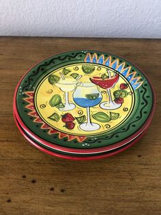 a small bowl on a wooden table with an image of two wine glasses in it