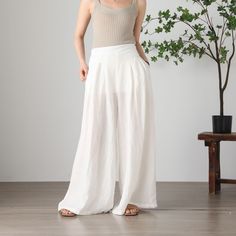 "Cool and comfortable for hot summer days, this apricot wide leg pants is elegant and stylish.    It is a wonderful wardrobe staple that's a timeless classic you'll wear again and again.  All our items are Tailored and Handmade and Made to Order ,I can make Any Size . I design new styles every week, please collect my store. I believe that you will meet your favorite styles. ★★FEATURES Linen 55% + Cotton 45% ( Medium Weight，Comfortable, Breathable and Washed Soft fabric) Has lining Two side pocke Baggy Wide Leg Pants For Beach, Baggy Summer Vacation Bottoms, Baggy Wide Leg Vacation Pants, Bohemian Summer Pants In Solid Color, Baggy Wide Leg Beach Trousers, White Relaxed Fit Harem Pants For Summer, Summer Wide-leg Harem Pants, Summer White Relaxed Fit Harem Pants, Summer Loose Fit Ankle-length Harem Pants