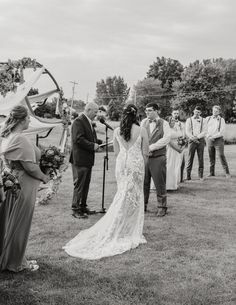 the bride and groom are getting married in front of their guests at this outdoor ceremony