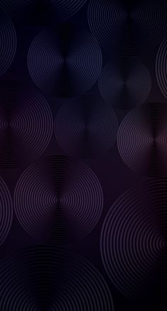 an abstract background with circles in purple and blue colors on a black background that is slightly blurry