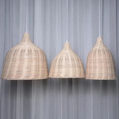 three hanging lights made out of wicker