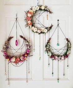 two wreaths with flowers hanging on the wall