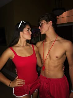 two people standing next to each other in swimsuits