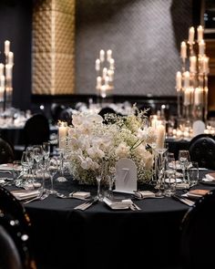 an elegant table setting with candles and flowers