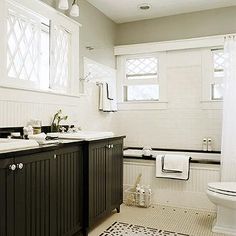 a white and black bathroom with two sinks