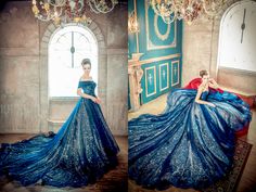 two women in blue gowns posing for the camera with chandeliers hanging from the ceiling