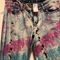 a pair of jeans with paint splattered on them