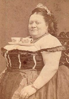 an old photo of a woman holding a tea cup