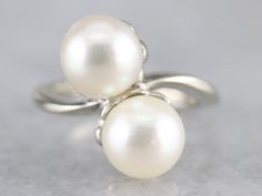 This luxurious pearl ring has a classical bypass style that is timeless! The pearls sit in the center of curving, polished heads in gleaming 14 karat white gold. Easy to wear day or night, this vintage ring is elegant and beautiful. Metal: 14K White Gold Gem: 2 Pearls Gem Measurements: 8 mm, Round Ring Size: 4.25 Marks: "14K" Stamped on the inside band Pearl Ring Design, Yellow Gold Sapphire Ring, June Birthstone, Round Rings, White Gold Ring, Multi Stone Ring, June Birth Stone, Vintage Ring, Anniversary Ring