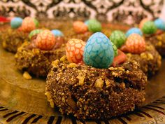 there are some cookies decorated with colorful candies on top of each other and eggs in the middle