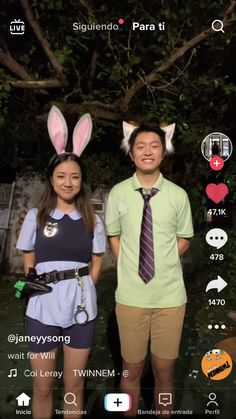 two people standing next to each other wearing bunny ears