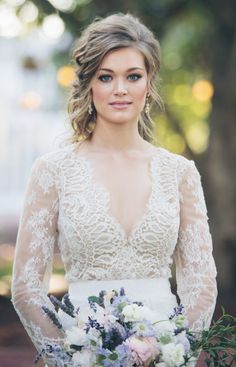 a woman in a wedding dress holding a bouquet