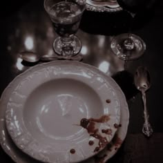 a dirty plate and silverware on a table