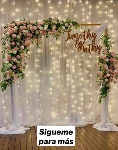 the wedding arch is decorated with pink flowers and greenery