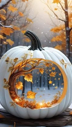 a white pumpkin sitting on top of a table in front of some trees and leaves