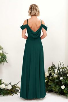 a woman in a green dress looking back