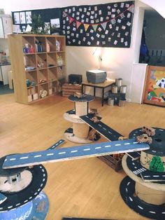 a model airplane is on display in a room with wooden floors and toys around it