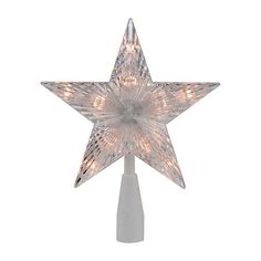 a lighted star decoration on top of a white pole