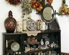 a shelf filled with lots of bottles and vases next to a wall mounted mirror