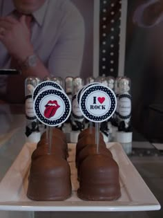 chocolate covered candies are sitting on a tray with stickers that say i love rock