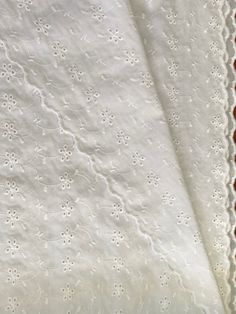 an old white table cloth with lace on it