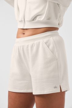 The easy, comfy shorts you want to wear the moment you get home—but cuter. They’re made from lightweight French terry with classic details like a high rise, side pockets, and a hidden internal drawstring. Fitwise, they're laid-back, loose, and hang off the body just right. For a luxe leisure look you can count on, pair them with the Sweet Escape Zip Up Hoodie. Sweat Shorts Set, Comfy Active Wear, Alo Shorts, Womens Onesie, Womens Capris, Comfy Shorts, Sweat Shorts, Bra Women, Low Key