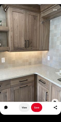 a kitchen with wooden cabinets and marble counter tops in the center, along with white tiles on the backsplash