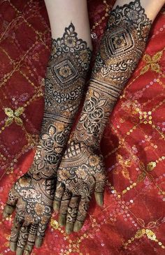 the feet and hands of a woman with henna tattoos