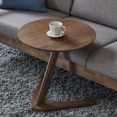 Introducing the Covis Side Table - the perfect solution for those who enjoy lounging in comfort and style. This modern and sleek solid wood round table measures 50cm in diameter and is designed to slide easily under your sofa, offering a convenient surface for holding snacks and beverages without taking up too much space. Crafted from high-quality oak wood, this table is sturdy and durable, featuring v-shaped legs that keep it from wobbling or ti Furnitur Ruang Keluarga, Bedside Table Design, Solid Wood Side Table, Small Bedside Table, Wooden Side Table, Side Coffee Table, Wooden Sofa, Sofa Side Table