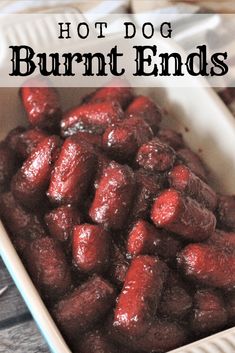 hot dog burnt ends in a white dish on a wooden table with text overlay