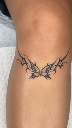 a tattoo on the side of a woman's stomach