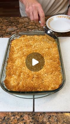 a man is making a casserole on the kitchen counter with a bowl and spoon