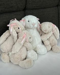 a pile of stuffed animals sitting on top of a couch