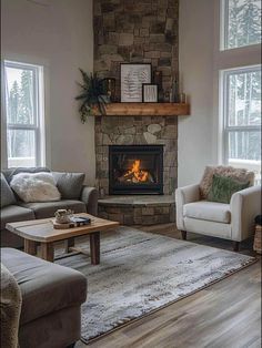 a living room with two couches and a fire place in the middle of it