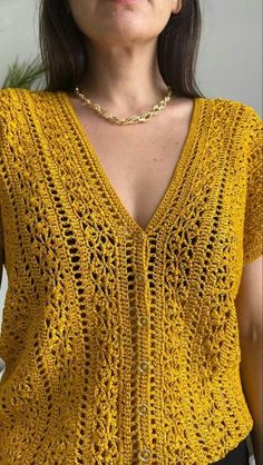 a woman wearing a yellow crochet top